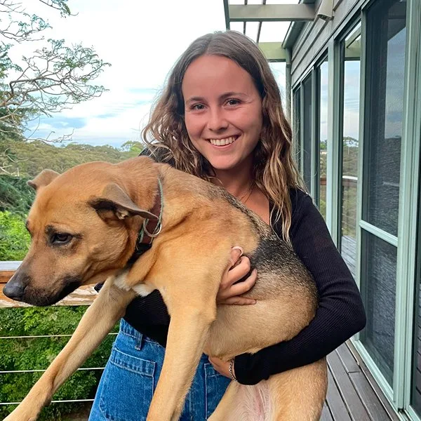 Hannah, Pack Leader at Stellar Paws, holding Nelly after a professional off-leash walking session on Sydney's Lower North Shore