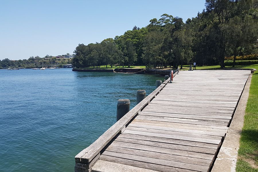 Wooden pier at Sawmillers Reserve, a hidden gem dog park in McMahons Point with waterfront access