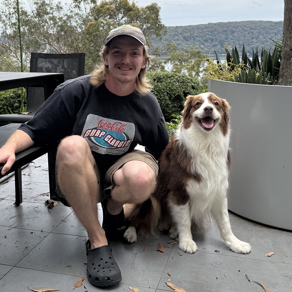 Ed, professional dog walker at Stellar Paws, with an Australian Shepherd during an off-leash group walking session in Sydney